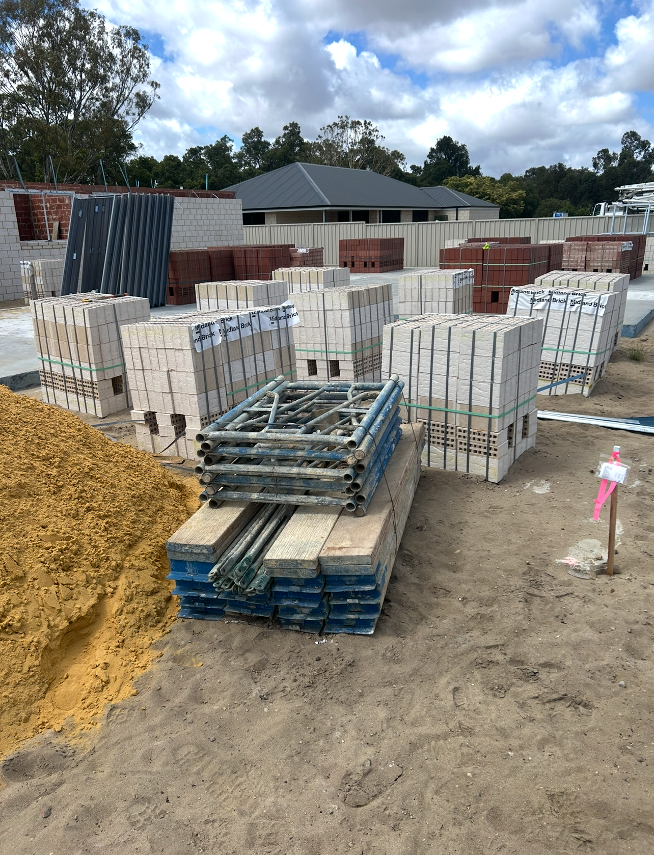 Containment Group brickies kit beside Midland Brick pallets